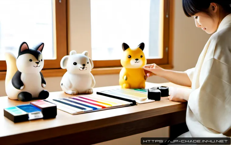 캐릭터 디자인과 브랜딩 스토리의 접목 - Photorealistic creative studio scene showing a Japanese character designer arranging hand-sculpted m...